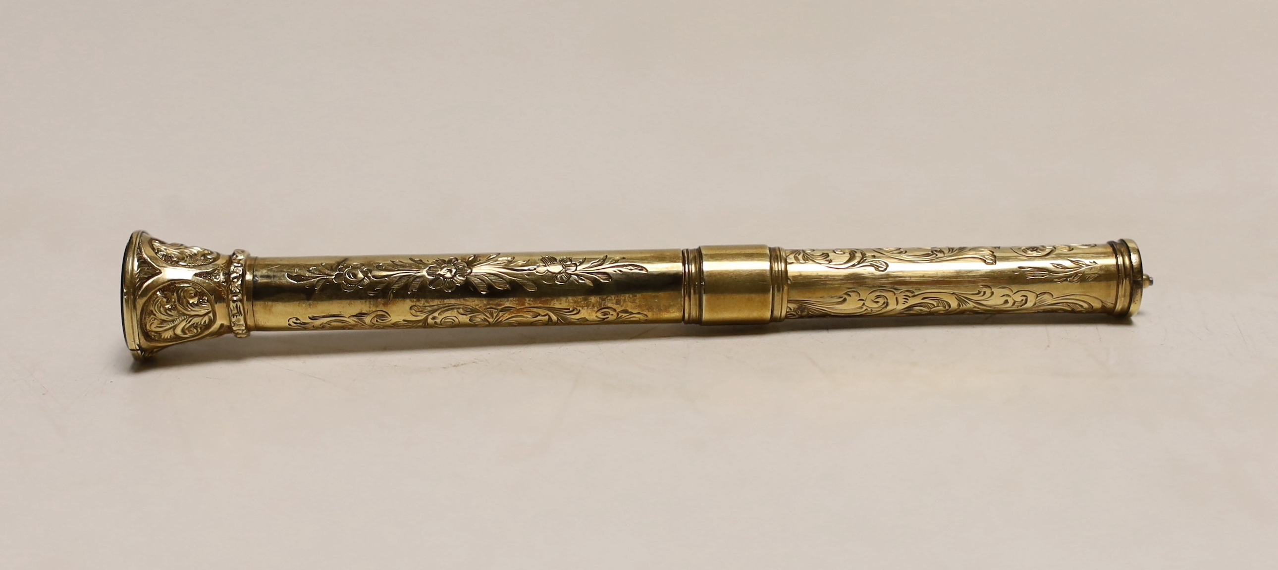 A late Victorian engraved yellow metal overlaid propelling pen and pencil, with bloodstone set terminal, 95mm.